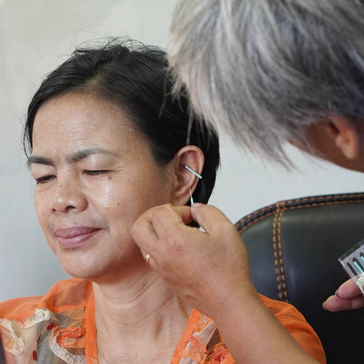 A Benguet State University employee getting an Acudetox treatment from a SIFCare volunteer.